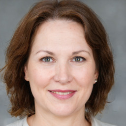 Joyful white adult female with medium  brown hair and brown eyes