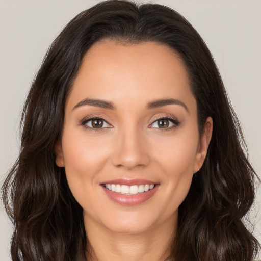 Joyful white young-adult female with long  brown hair and brown eyes