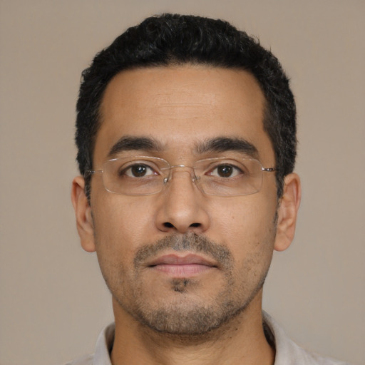 Neutral latino adult male with short  black hair and brown eyes