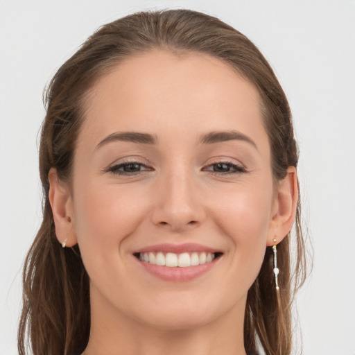 Joyful white young-adult female with long  brown hair and grey eyes