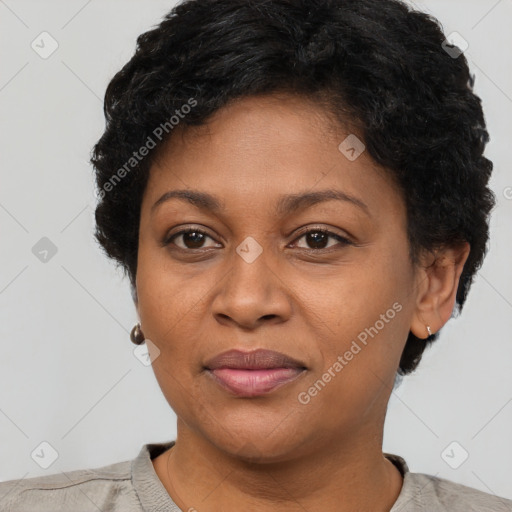 Joyful black adult female with short  brown hair and brown eyes
