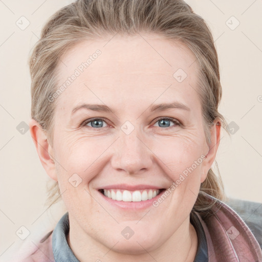 Joyful white young-adult female with medium  brown hair and blue eyes