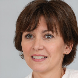 Joyful white adult female with medium  brown hair and brown eyes