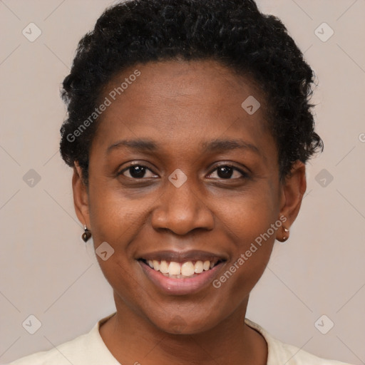 Joyful black young-adult female with short  black hair and brown eyes