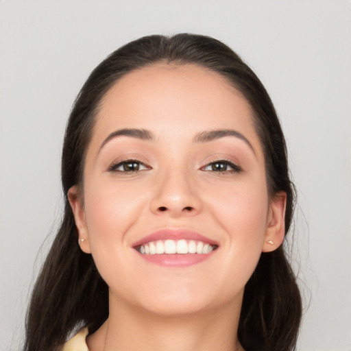 Joyful white young-adult female with long  brown hair and brown eyes