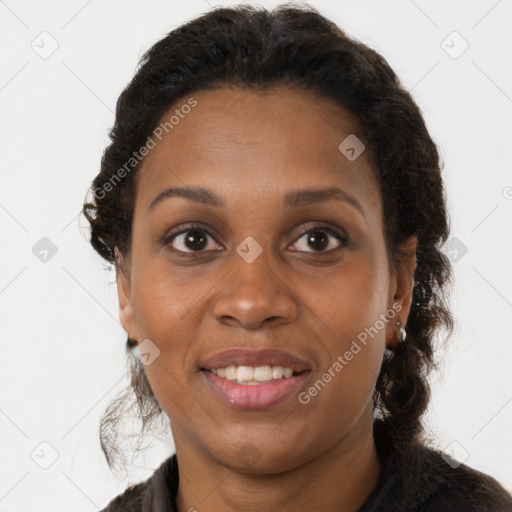 Joyful black young-adult female with long  brown hair and brown eyes