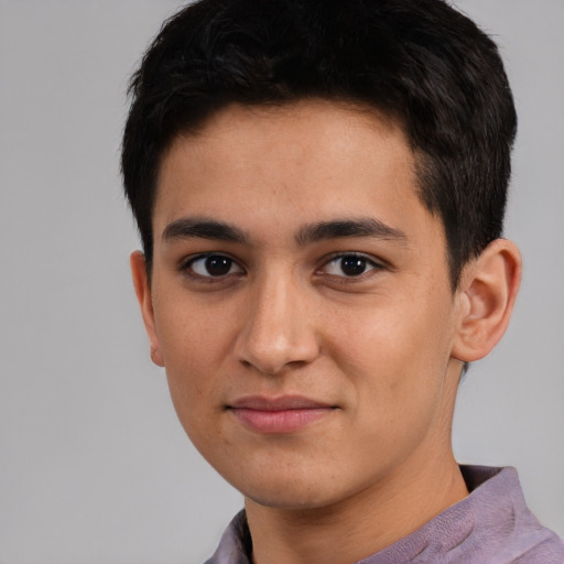 Joyful white young-adult male with short  black hair and brown eyes