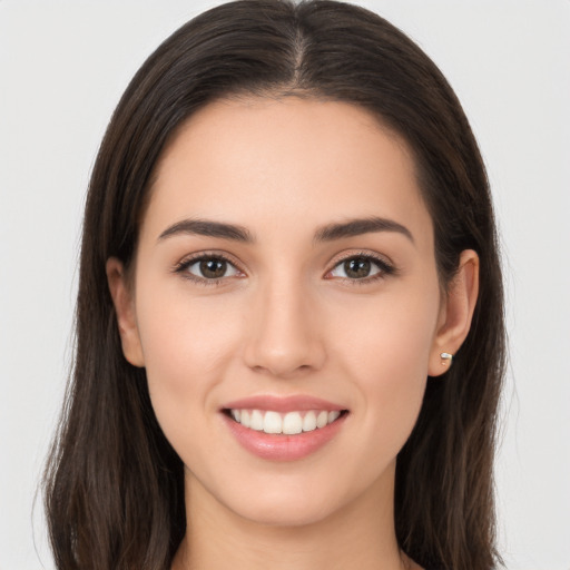 Joyful white young-adult female with long  brown hair and brown eyes