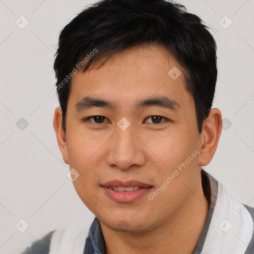 Joyful asian young-adult male with short  black hair and brown eyes