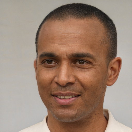 Joyful latino adult male with short  brown hair and brown eyes