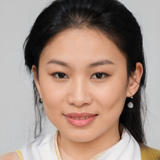 Joyful asian young-adult female with medium  brown hair and brown eyes