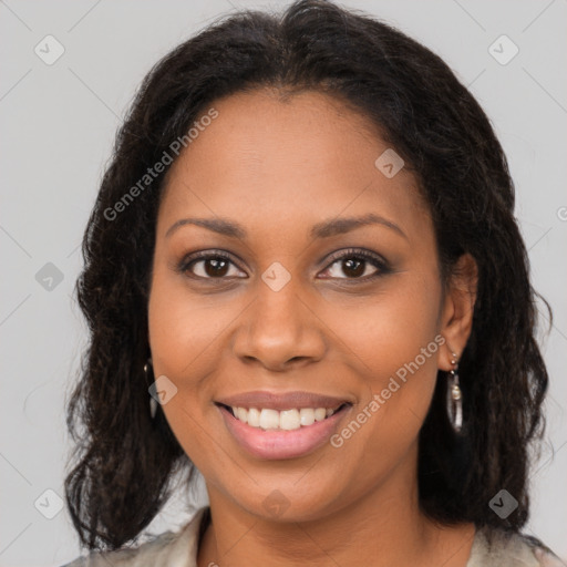 Joyful black young-adult female with long  brown hair and brown eyes