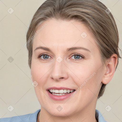 Joyful white adult female with medium  brown hair and grey eyes