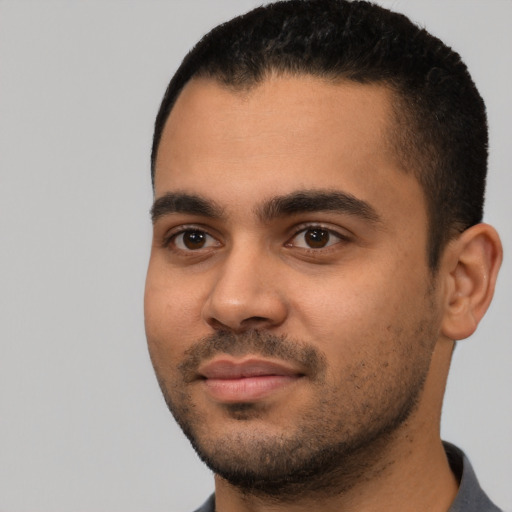 Joyful latino young-adult male with short  black hair and brown eyes