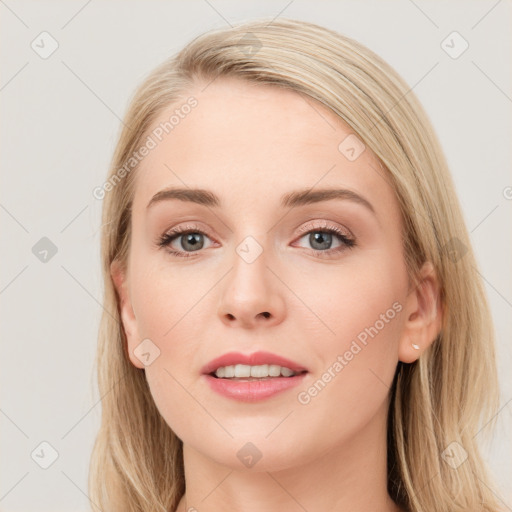 Joyful white young-adult female with long  brown hair and blue eyes