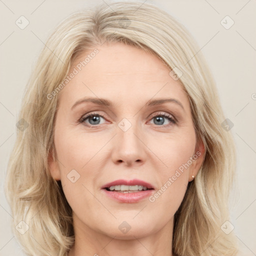 Joyful white adult female with medium  brown hair and blue eyes