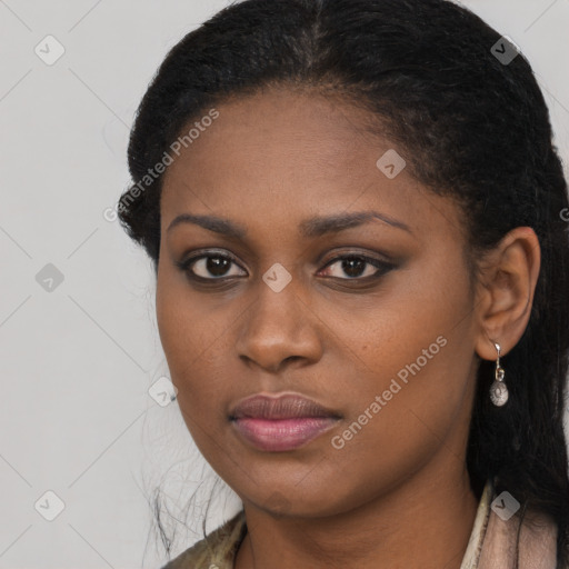 Joyful black young-adult female with long  black hair and brown eyes