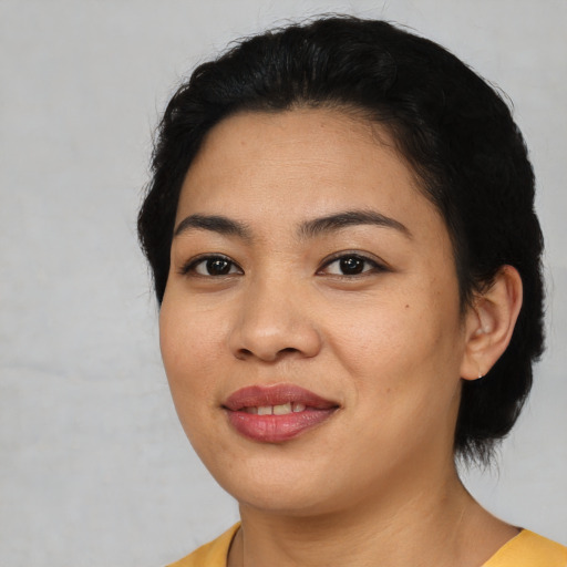 Joyful asian young-adult female with short  black hair and brown eyes