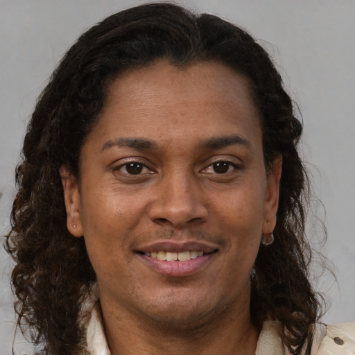 Joyful black adult female with medium  brown hair and brown eyes