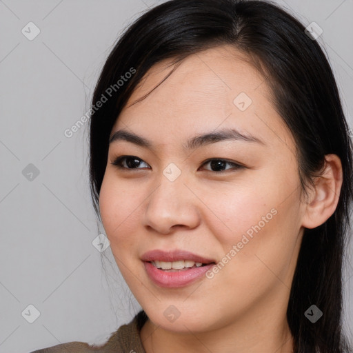 Joyful asian young-adult female with long  brown hair and brown eyes