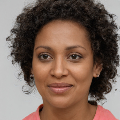 Joyful black young-adult female with medium  brown hair and brown eyes