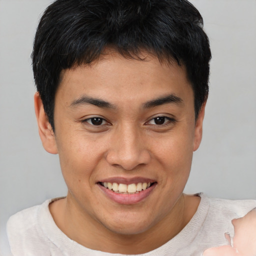 Joyful asian young-adult male with short  brown hair and brown eyes