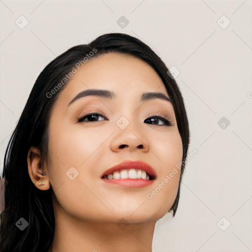 Joyful asian young-adult female with long  black hair and brown eyes