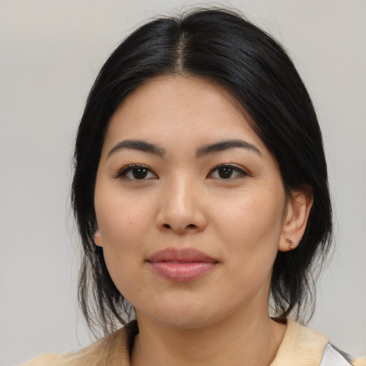 Joyful asian young-adult female with medium  black hair and brown eyes