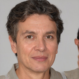 Joyful white middle-aged male with short  brown hair and brown eyes