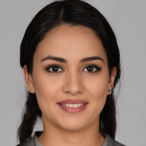 Joyful white young-adult female with medium  black hair and brown eyes