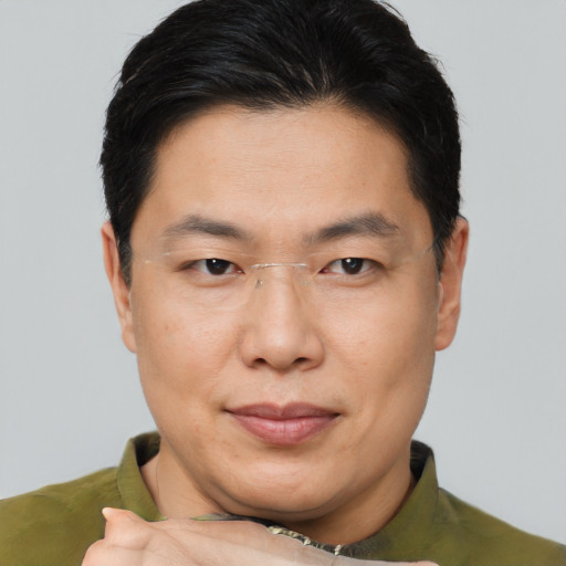 Joyful asian adult male with short  brown hair and brown eyes