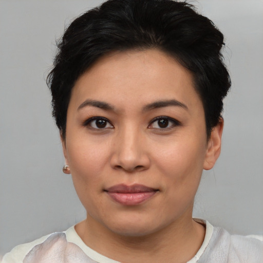 Joyful asian young-adult female with short  black hair and brown eyes