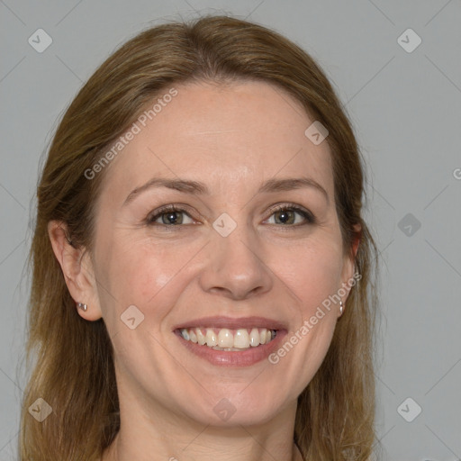 Joyful white adult female with medium  brown hair and grey eyes