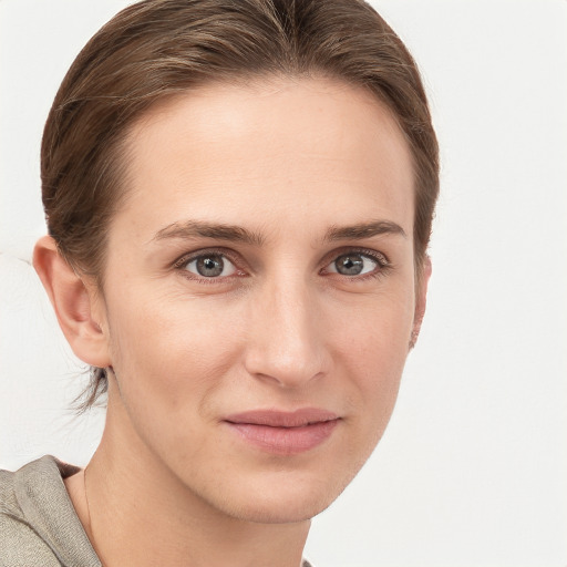 Joyful white young-adult female with short  brown hair and grey eyes