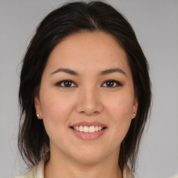 Joyful white young-adult female with medium  brown hair and brown eyes