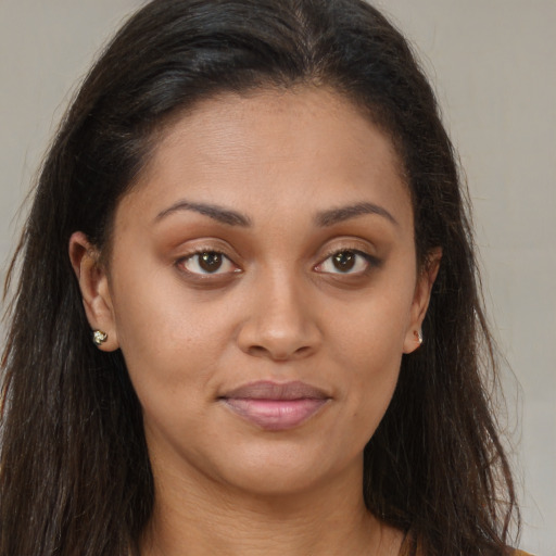 Joyful black young-adult female with long  brown hair and brown eyes