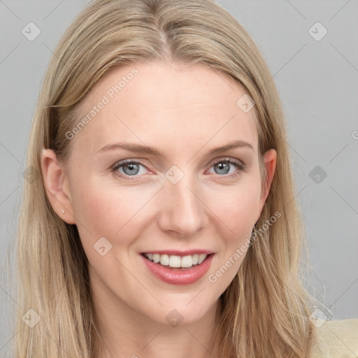 Joyful white young-adult female with long  brown hair and blue eyes