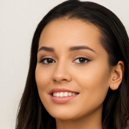 Joyful latino young-adult female with long  black hair and brown eyes