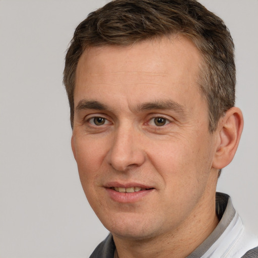 Joyful white adult male with short  brown hair and brown eyes