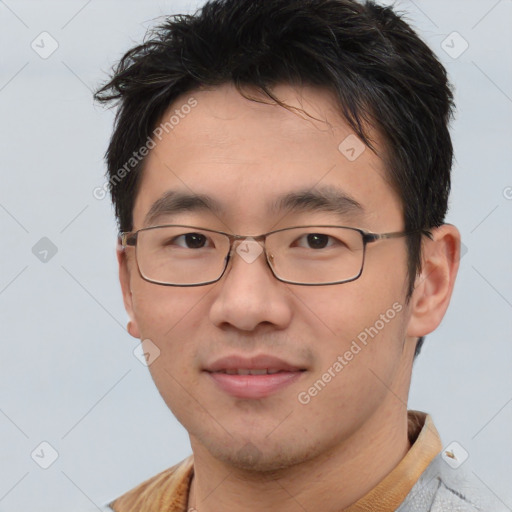 Joyful asian young-adult male with short  brown hair and brown eyes