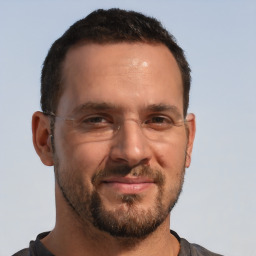 Joyful white adult male with short  brown hair and brown eyes