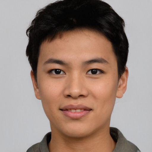 Joyful asian young-adult male with short  black hair and brown eyes