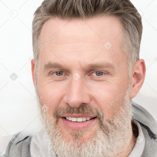 Joyful white adult male with short  brown hair and grey eyes