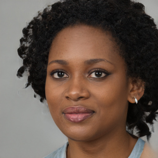 Joyful black young-adult female with medium  black hair and brown eyes