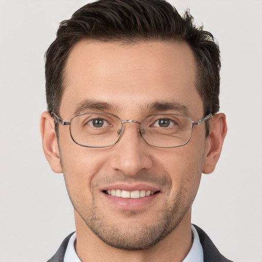 Joyful white adult male with short  brown hair and brown eyes