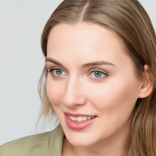 Joyful white young-adult female with long  brown hair and grey eyes