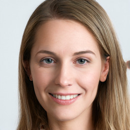 Joyful white young-adult female with long  brown hair and blue eyes