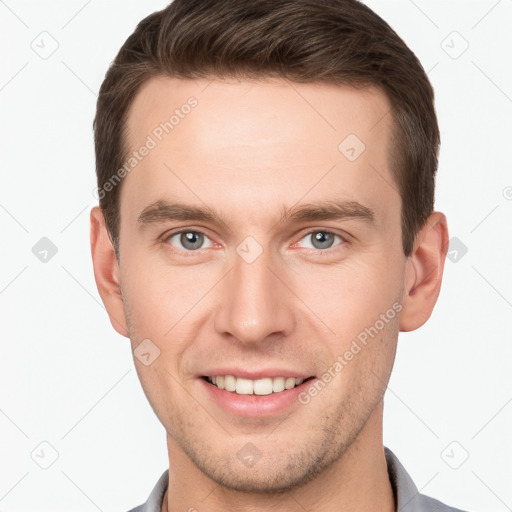 Joyful white young-adult male with short  brown hair and grey eyes