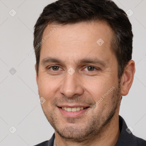 Joyful white adult male with short  brown hair and brown eyes