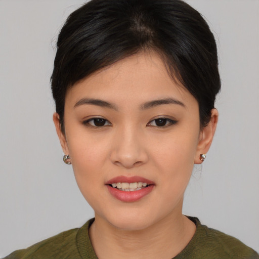 Joyful asian young-adult female with medium  brown hair and brown eyes
